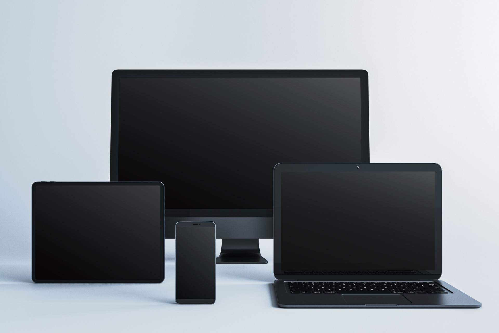 Digital device mockup with blank screens including desktop, laptop, tablet, and smartphone on light background for display presentation template. 3D Rendering